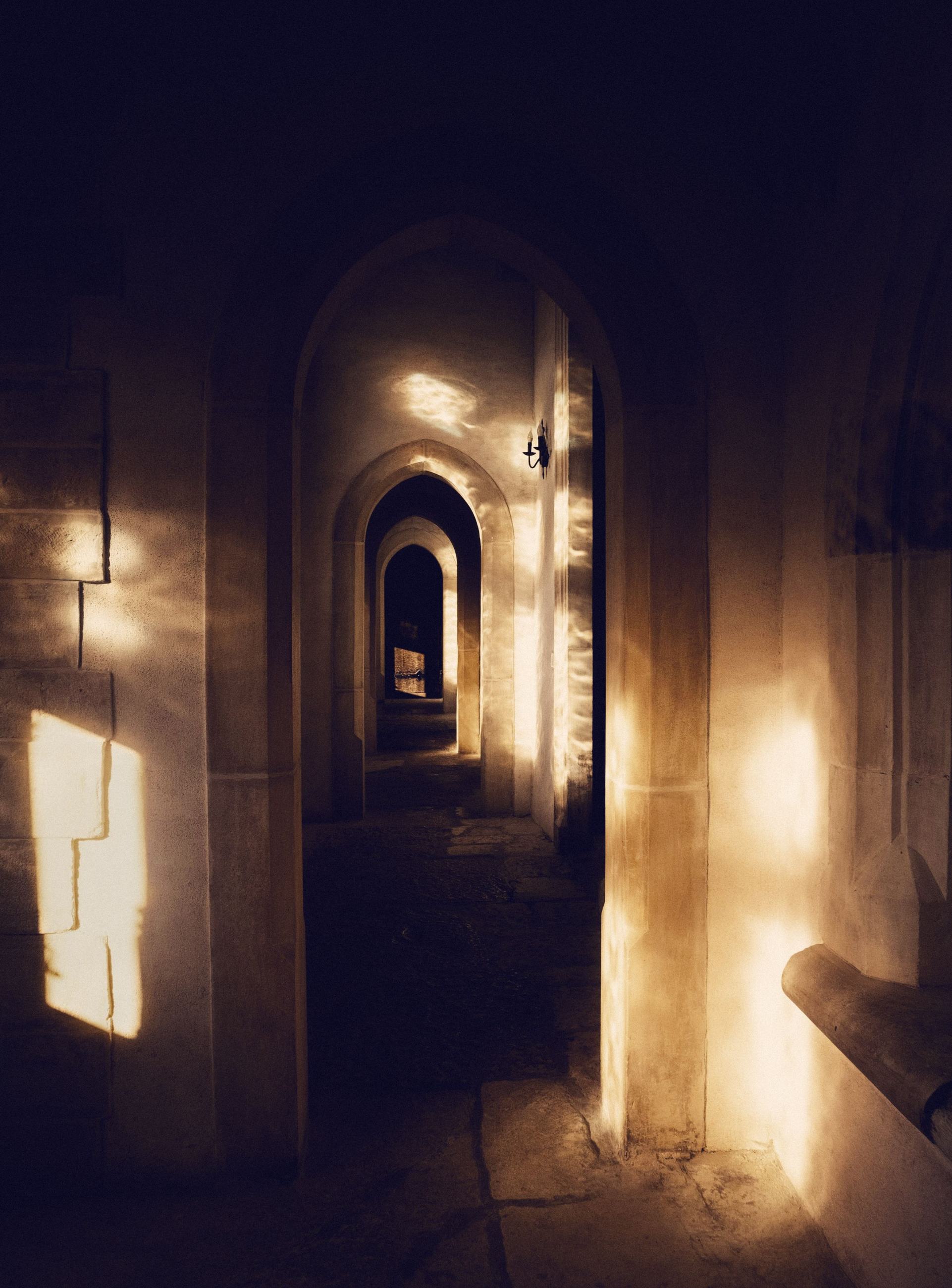 A corridor of arches lit with warm light