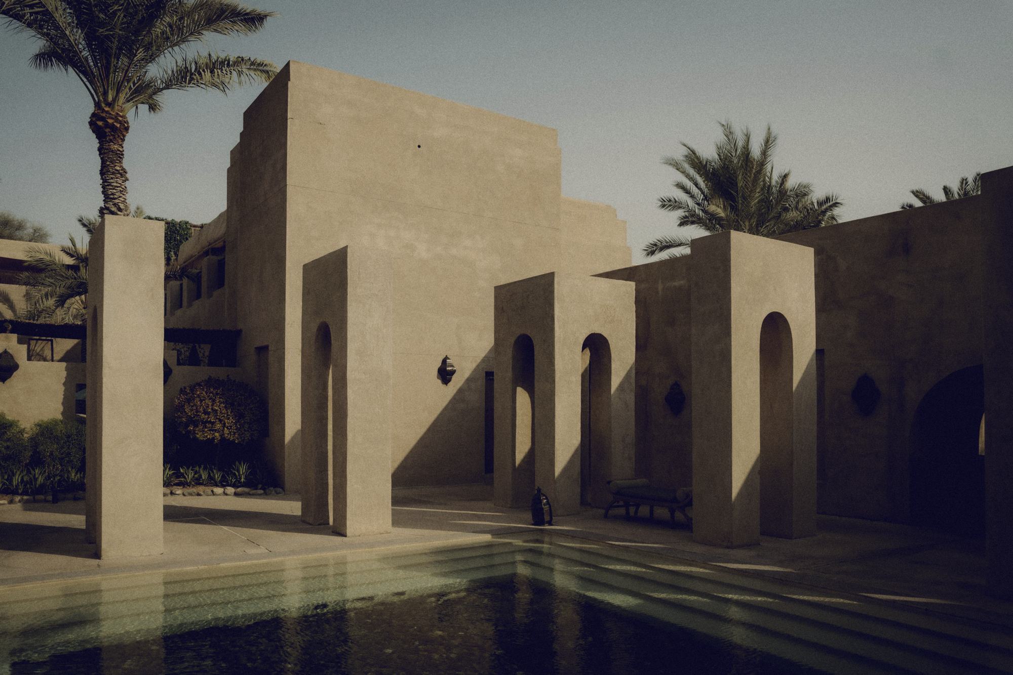 A calm courtyard of arches and water