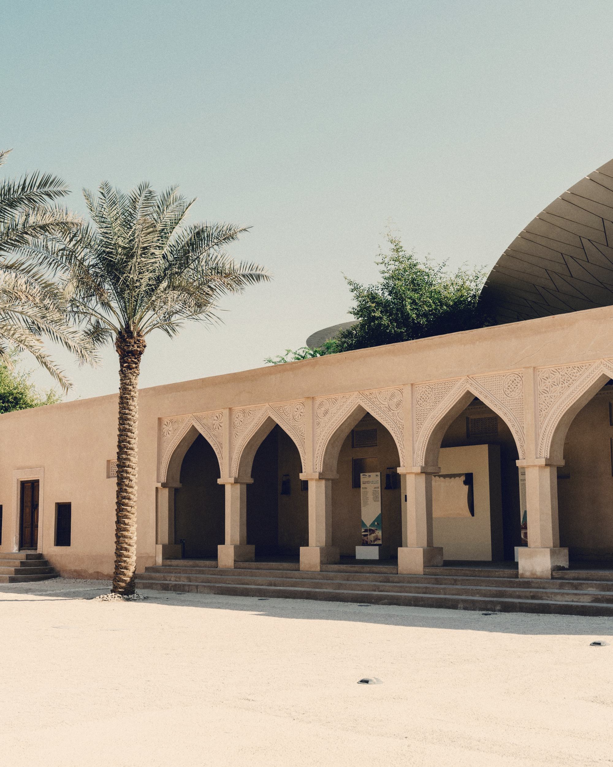 A traditional arcade with palm trees
