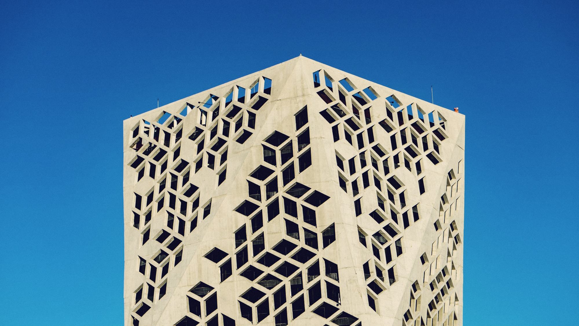 A modern building with a geometric lattice façade