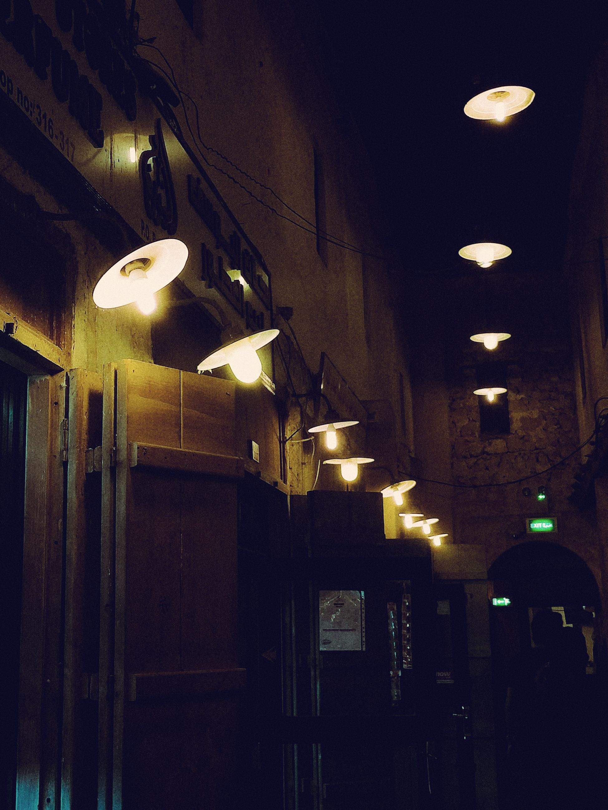 Warm lamps along a passage in Souq Waqif